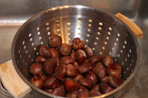 Rinsing chestnuts for roasting.
