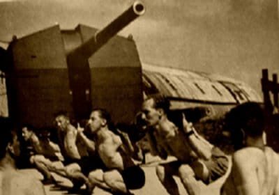 A group of men performing squats as part of their exercise routine.
