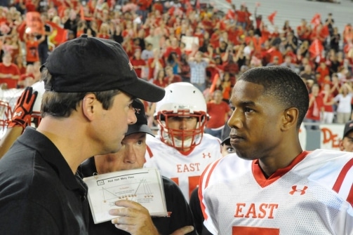 Coach Taylor Vince giving instructions to footballers.