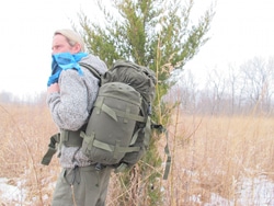 Creek Stewart carrying training bag in forest.