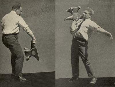 Vintage man gripping by lifting anvil wearing shirt and tie.