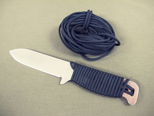 Full tang survival knife with Paracord wrapped around handle.