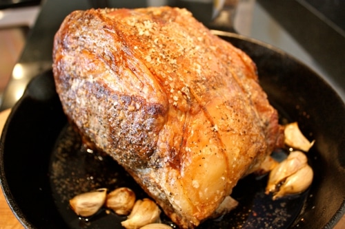 Roasting of ribs in the pan with garlic cloves.