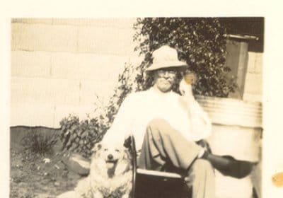 A nostalgic photo capturing the bond between a man and his loyal dog.