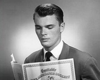 A man in a suit financially protecting himself by reading a newspaper.
