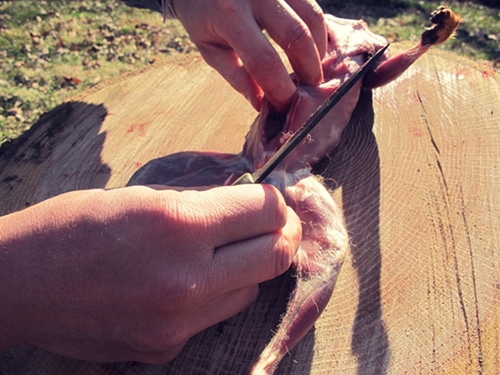 A man inserting two fingers into the slit.