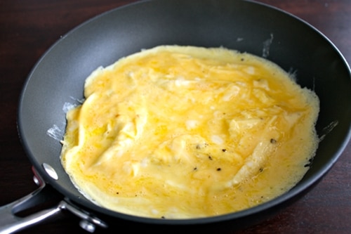 The whipped eggs in a pan.