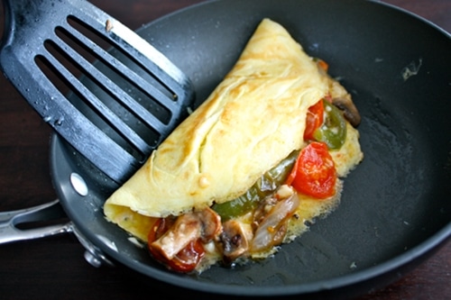 Picking the Omelet with spatula from pan.