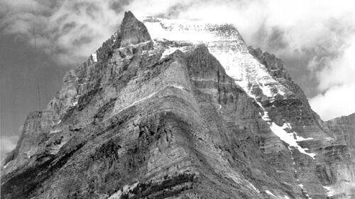 A stunning black and white photo capturing the majestic beauty of a snow-covered mountain.