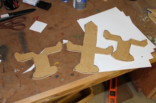 Three pieces of a wooden sword on the table.