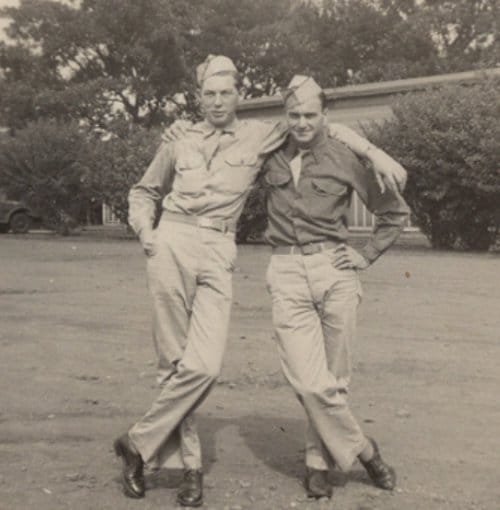 Two men in military uniforms posing for a Manvotional.