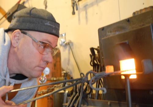 A man heating the iron in furnace. 