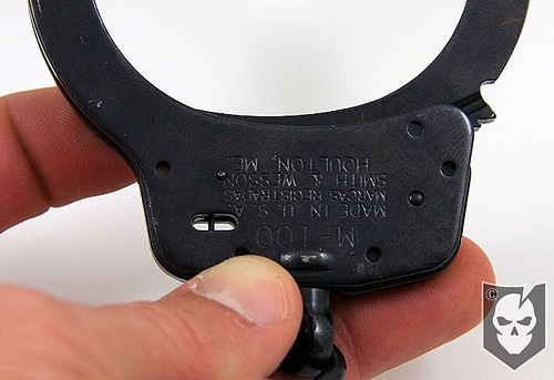 Double lock of handcuffs using pin. 