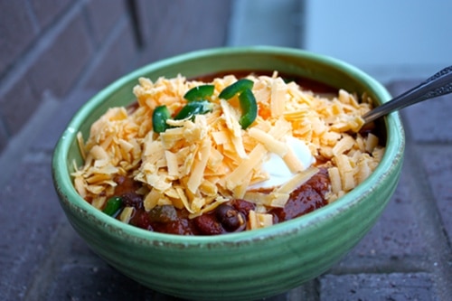 Venison chili with sour cream cheese served in a bowl. 