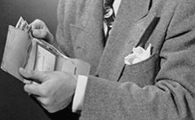 A man in a suit holding a wallet.