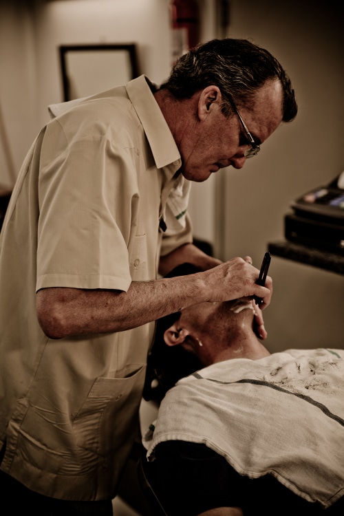 Front view of barber shaving.