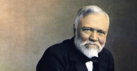 An old black-and-white photo of a bearded man.