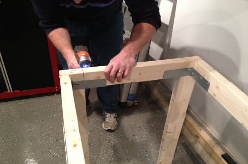 Man joining the plywood with ties.