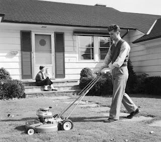 lawn Vintage man mowing the lawn.