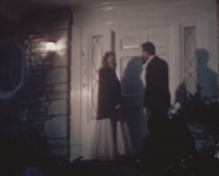 Vintage couple standing outside the door. 