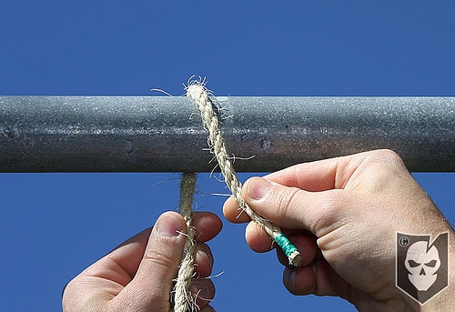 Man binding the rope with pipe.