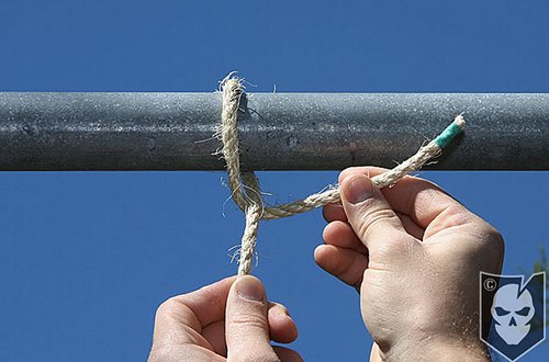 Man tighten the rope with pipe.