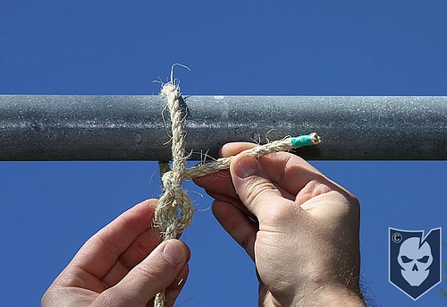 Man tighten the rope with pipe.