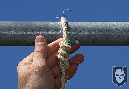 Man tighten the rope with pipe and securing each strand.