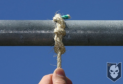 Man pull down rope for checking the tightness.