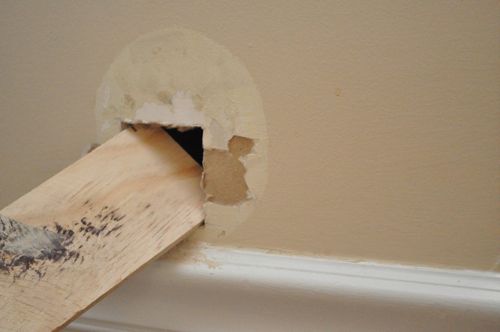 Inserting the bracket board on dry wall.