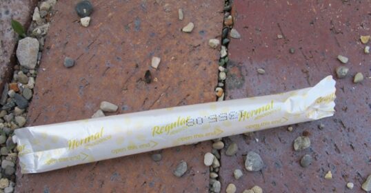 A Swiss Army Survival Tampon is sitting on the ground.