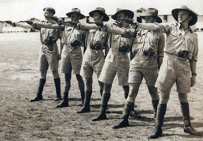 Men wearing shorts during gun shoot practicing.