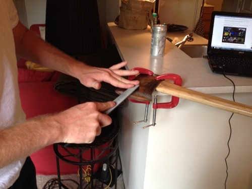 Filing antique axe sharpening blade.