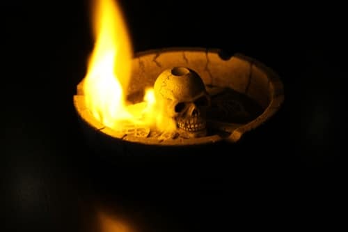 Skull in a burning fire bowl.