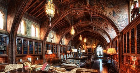 An ornate library with elaborate ceilings and intricate furniture.