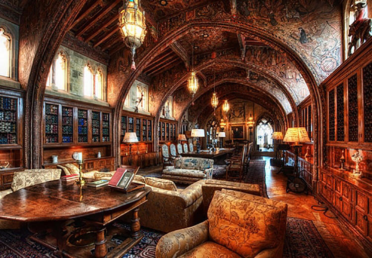 An ornate library with elaborate ceilings and intricate furniture.