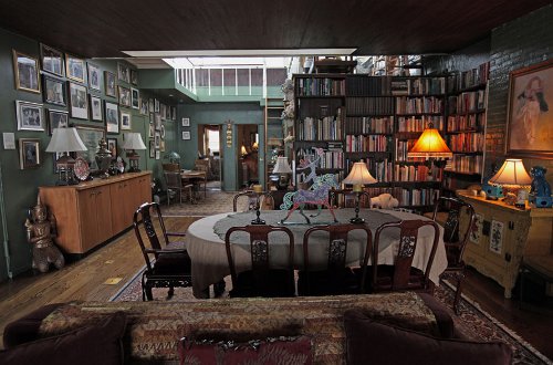 Vintage apartment, dining table, books and paintings on the wall illustration.