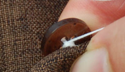 Sewing a button creating shank.