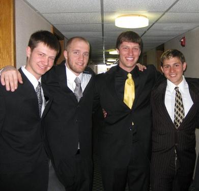 Vintage four young men smiling wearing suites black and white illustration.