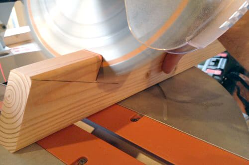 image12 cutting wood board with miter saw action shot close up