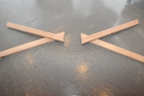DIY homemade wooden sawhorse legs done on floor.