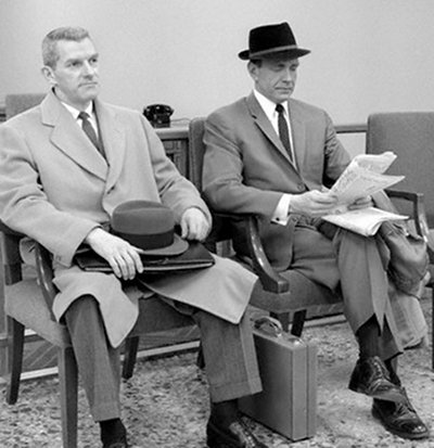 Vintage men businessmen waiting in chairs overcoats.