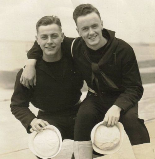 Vintage two young men holding hats and smiling black and white illustration.