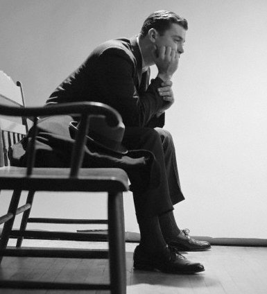 Vintage man businessman waiting on bench despondent.