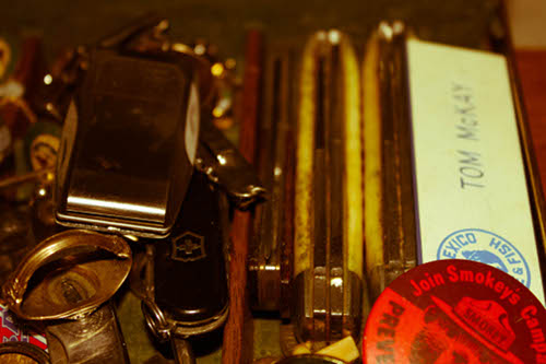 Vintage close-up on various pocket knives and my dad's new mexico game warden name tag.