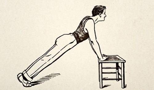 Young man doing push ups on short table illustration.