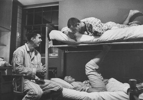 Vintage college roommates bunk beds pajamas laughing.