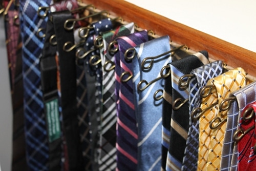 Tie rack in closet close up photo.