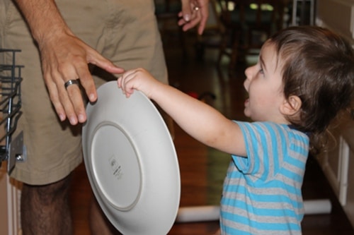 Kid holding a plate.