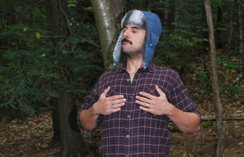 Vintage man in bomber hat taking deep breathing.